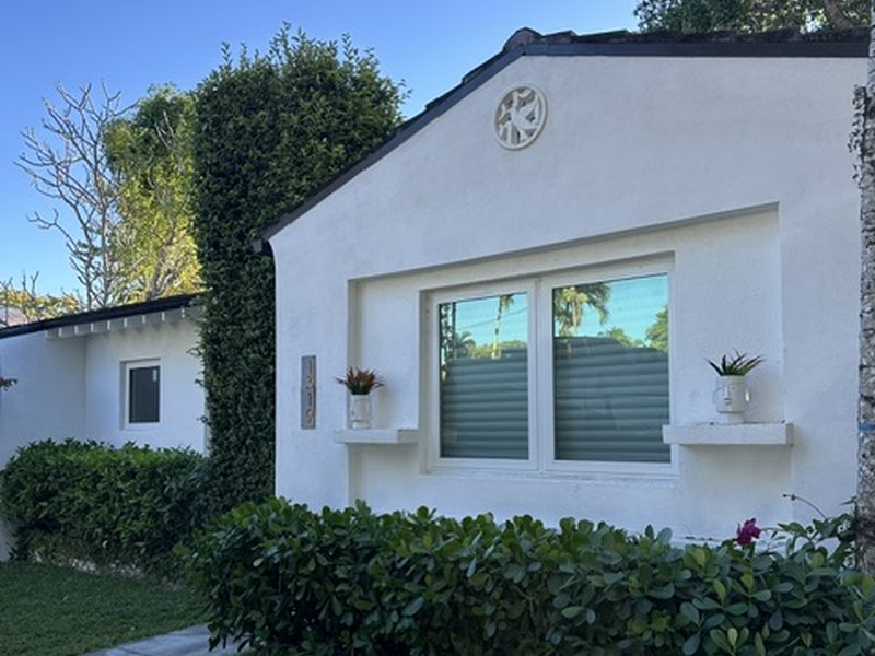 Impact windows on a white Mediterranean-style home in Coral Gables, finished to match the original architecture